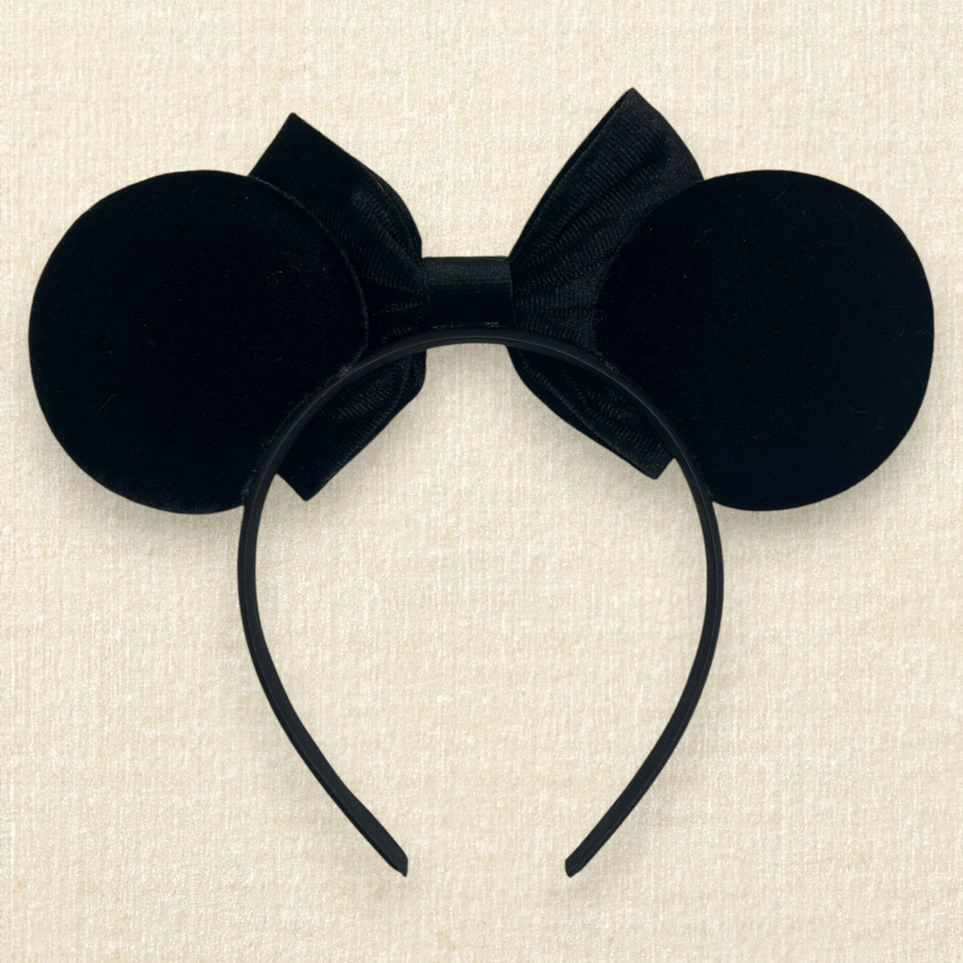 Black velvet mouse ears with black velvet bow and colorful rhinestones in a red, orange, yellow, and crystal ombre gradient pattern (back view)