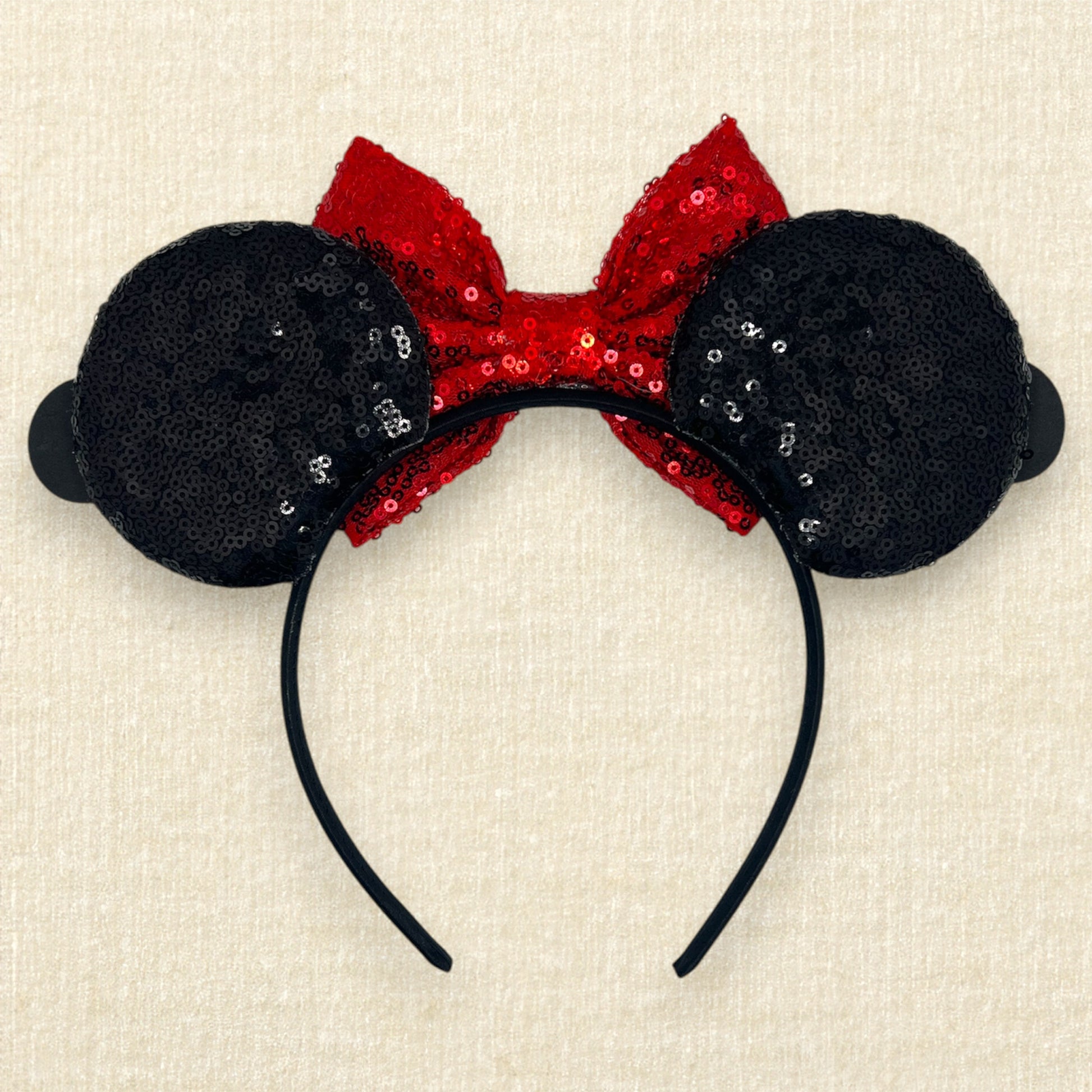 Black sequin mouse ears headband with red sequin bow and glitter mouse characters (back view)