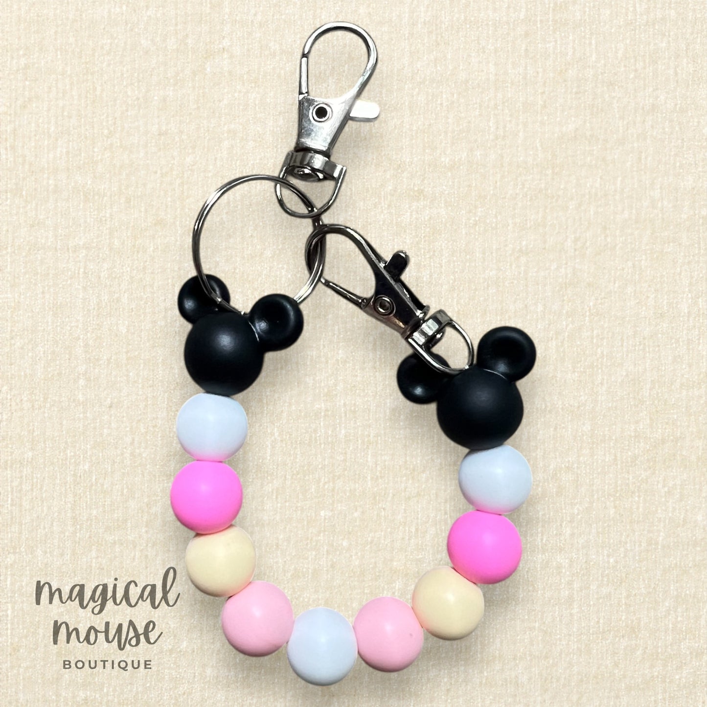 Colorful beaded keychain with Mickey Mouse ears on a beige background