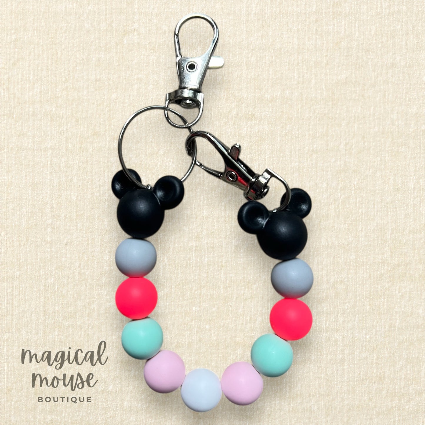 Colorful keychain with Mickey Mouse design on a beige background