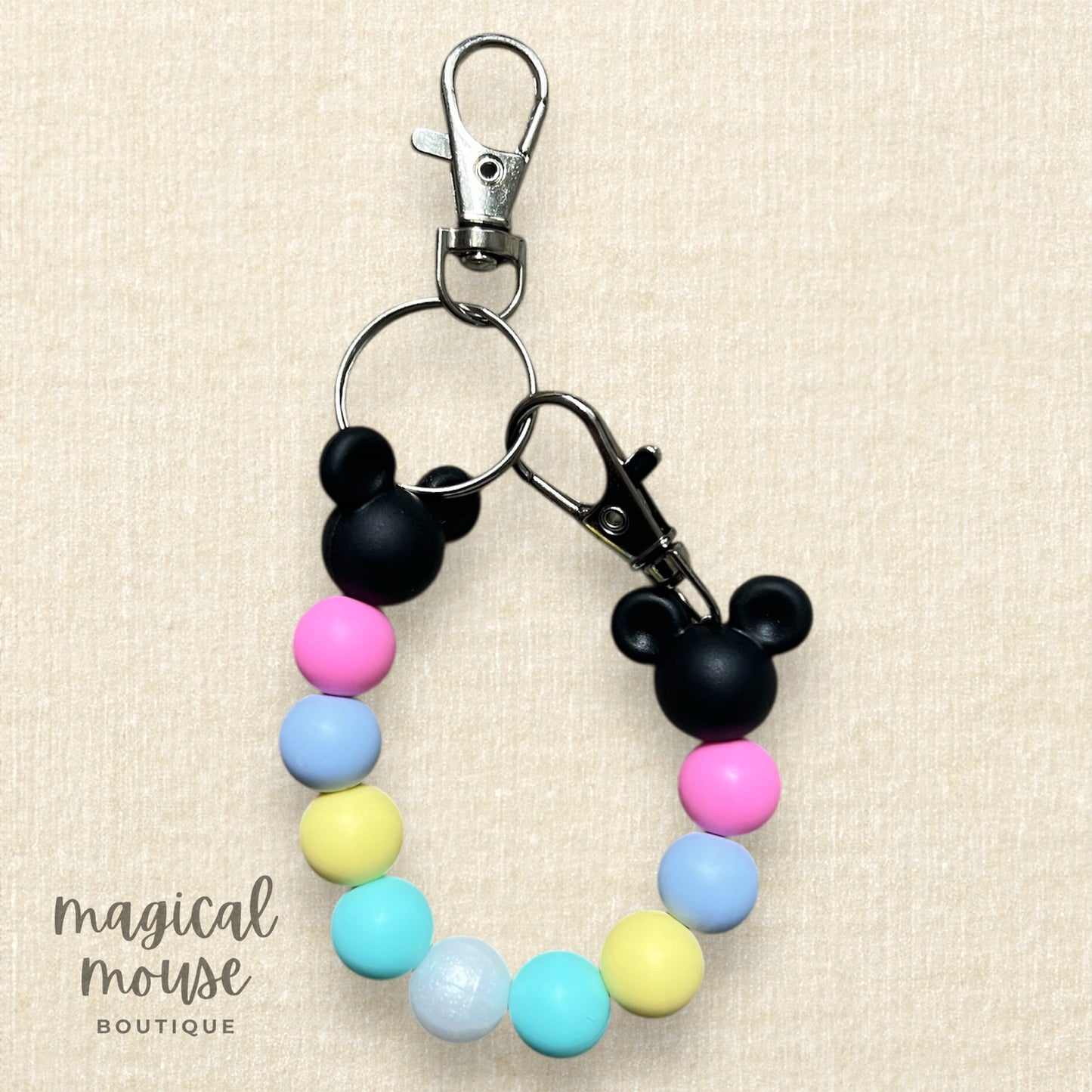 Keychain with colorful beads and Mickey Mouse heads on a beige background