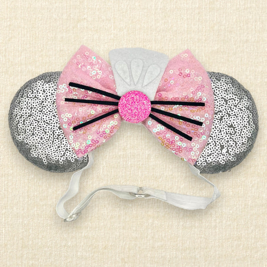 Silver mouse ears with pink sequin bow, mini white chef's hat, and pink glitter mouse nose with whiskers on an elastic headband