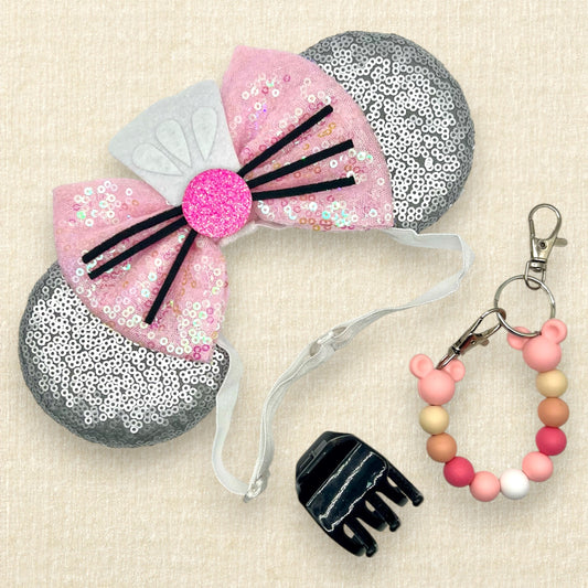 Silver mouse ears with pink sequin bow, mini white chef's hat, and pink glitter mouse nose with whiskers on an elastic headband; black claw clip; pink beaded mouse ears holder clip