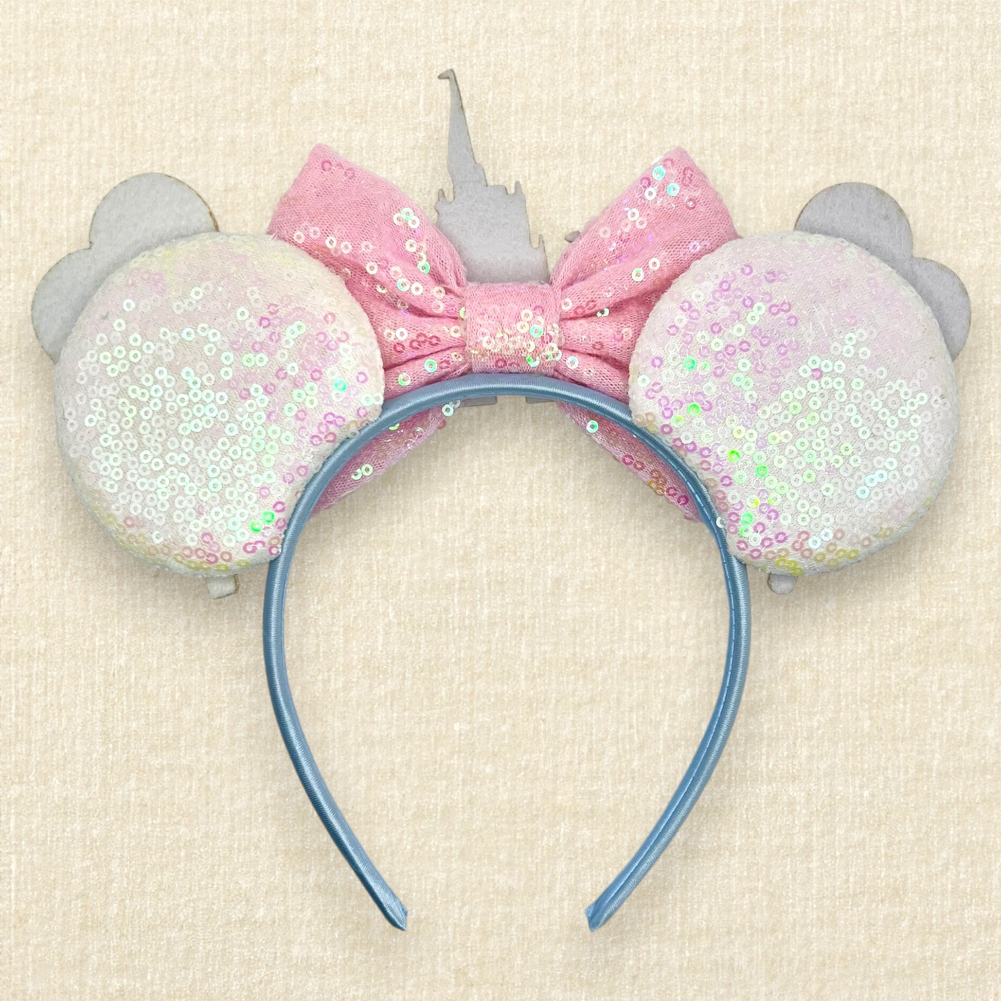 White sequin mouse ears with colorful mouse balloons and a pink bow with pastel pink and blue castle centerpiece (back view)