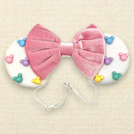 White velvet mouse ears with colorful pastel mouse pearls and pastel pink velvet bow on an elastic headband