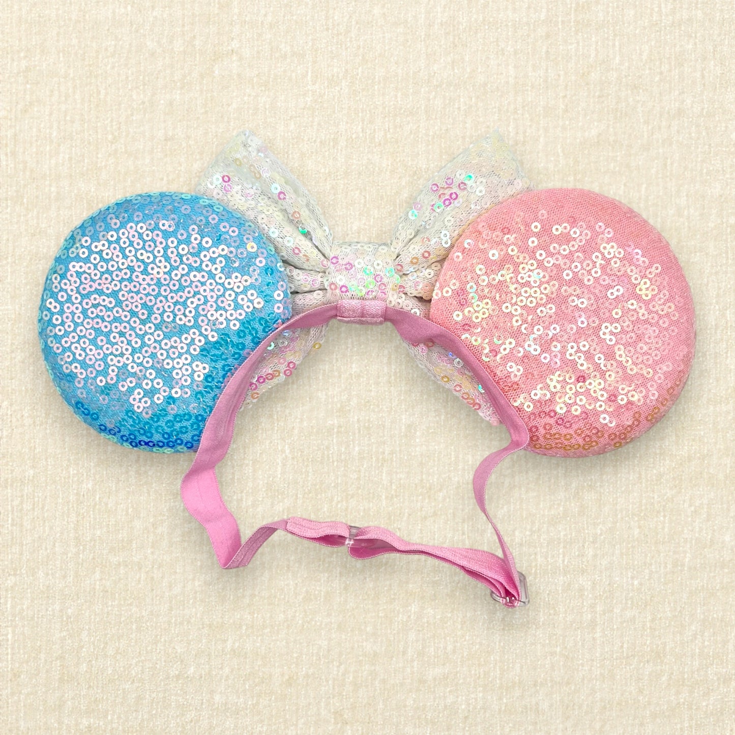 Pink and blue mouse ears with glitter mouse silhouettes, iridescent white sequin bow, and "Birthday Girl" text centerpiece