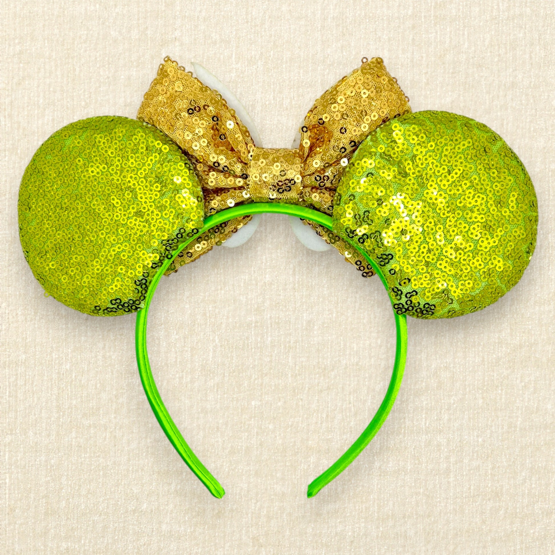 Light green sequin mouse ears headband with gold bow, glitter fairy wings, and pom-pom centerpiece (back view)