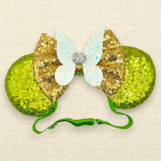 Light green sequin mouse ears with gold sequin bow and glitter fairy wings on an elastic headband