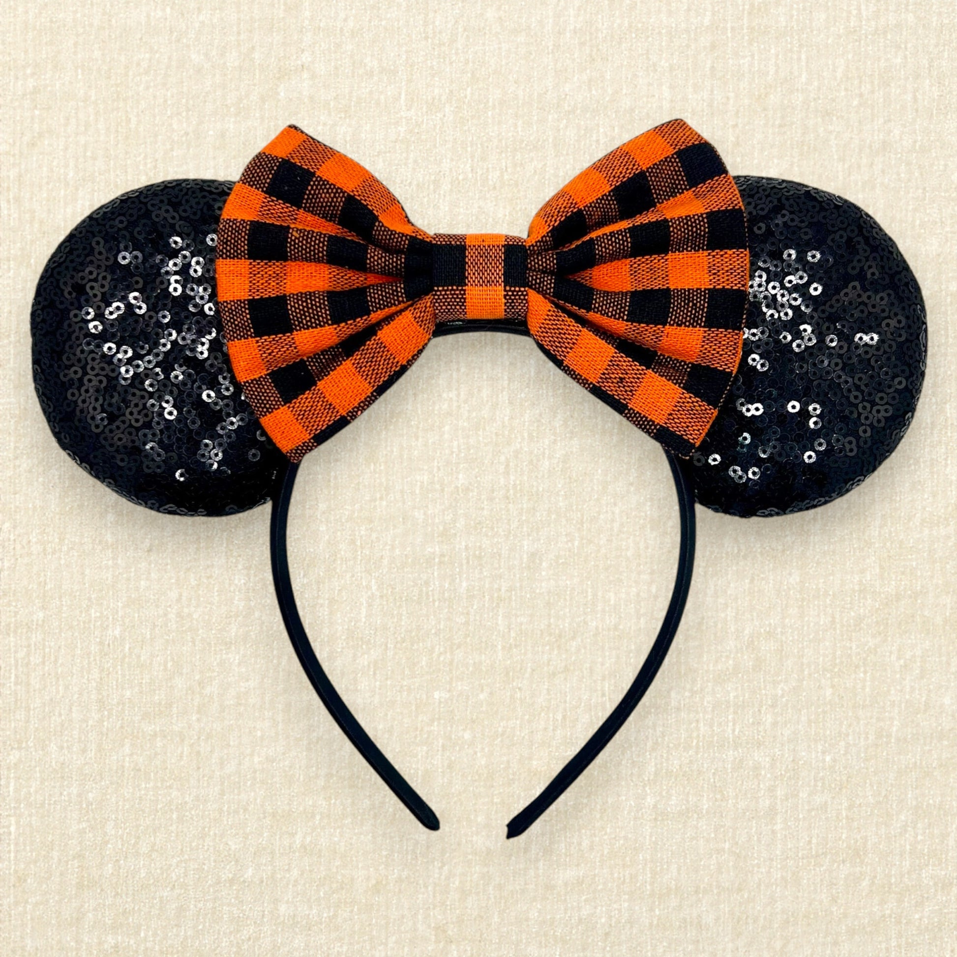 Fall-themed mouse ears with black sequin mouse ears and orange and black buffalo plaid bow