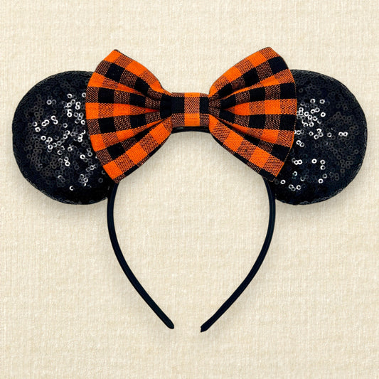 Fall-themed mouse ears with black sequin mouse ears and orange and black buffalo plaid bow