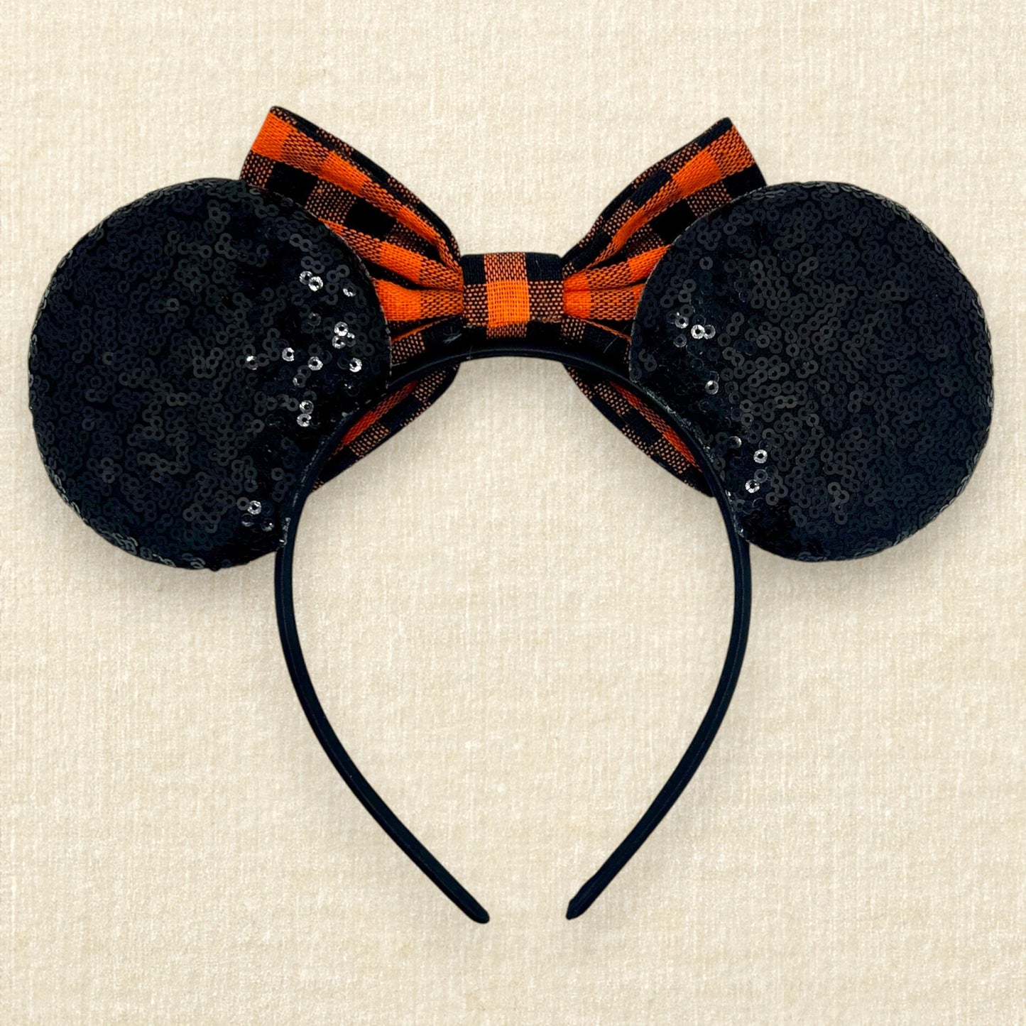 Fall-themed mouse ears with black sequin mouse ears and orange and black buffalo plaid bow (back view)