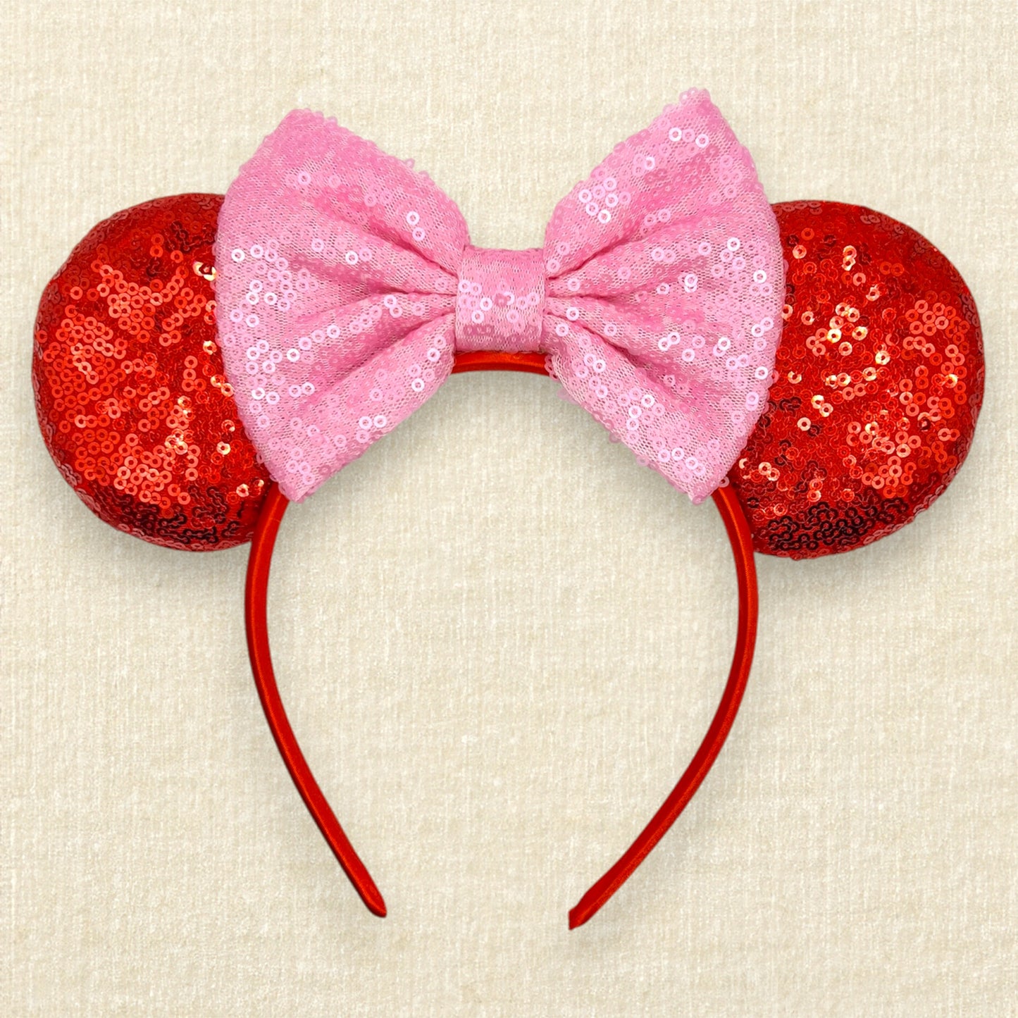 Red sequin mouse ears with a pink sequin bow