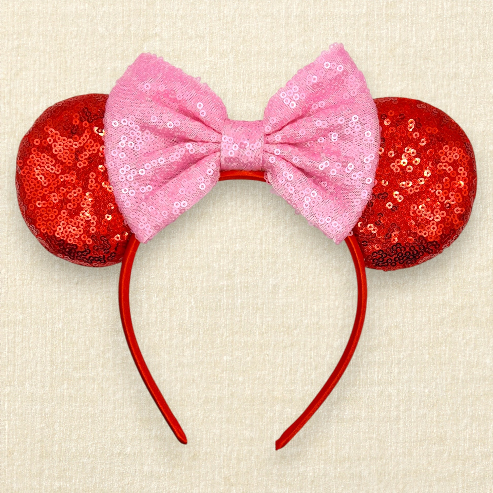 Red sequin mouse ears with a pink sequin bow