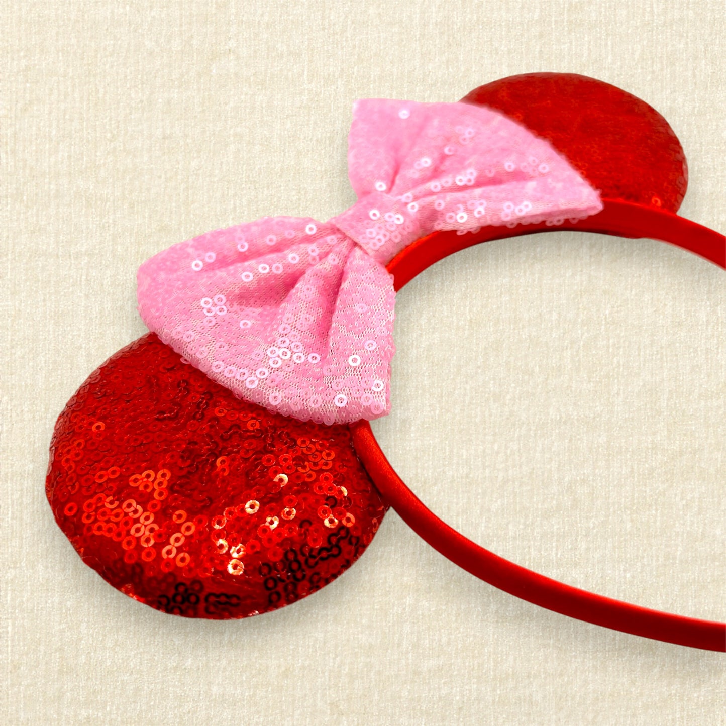 Red sequin mouse ears with a pink sequin bow