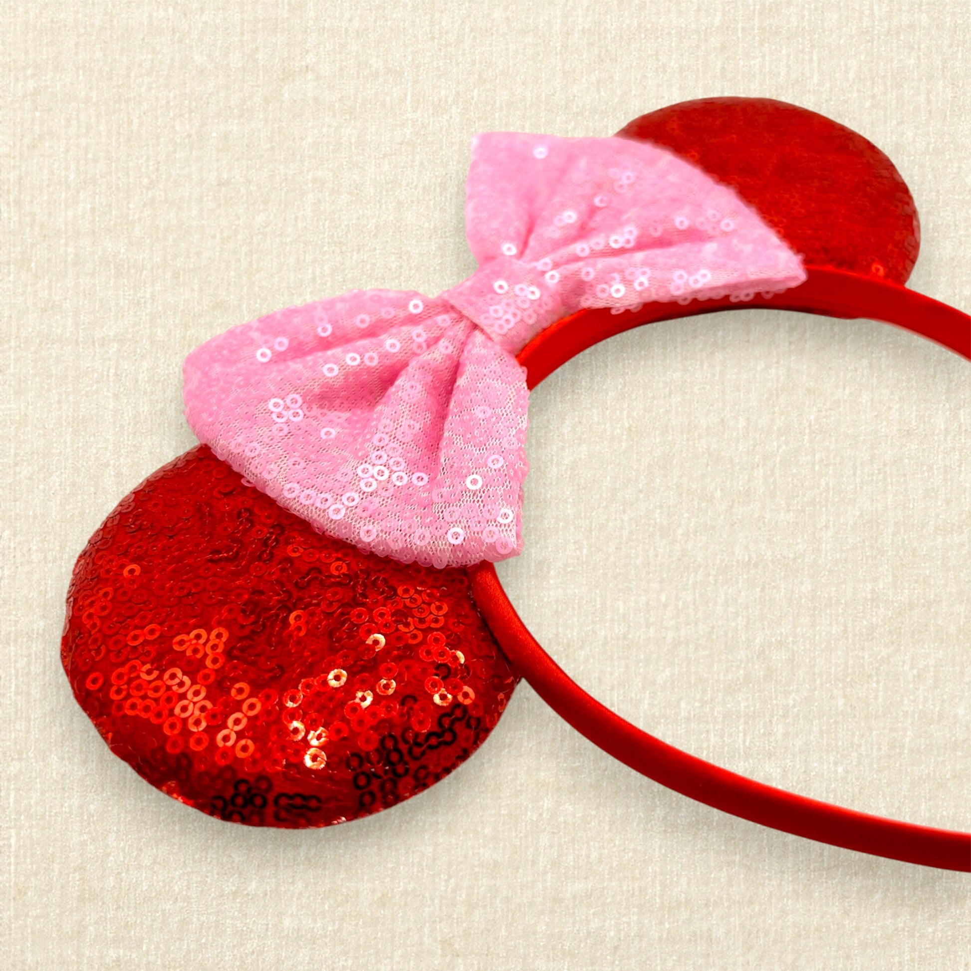 Red sequin mouse ears with a pink sequin bow