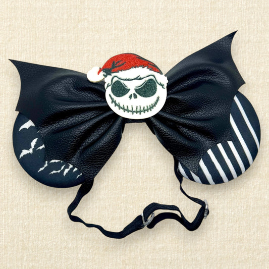 Halloween-themed mouse ears with black and white fabric ears, black faux leather bat wing bow, and glitter Sandy Claws centerpiece on an elastic headband