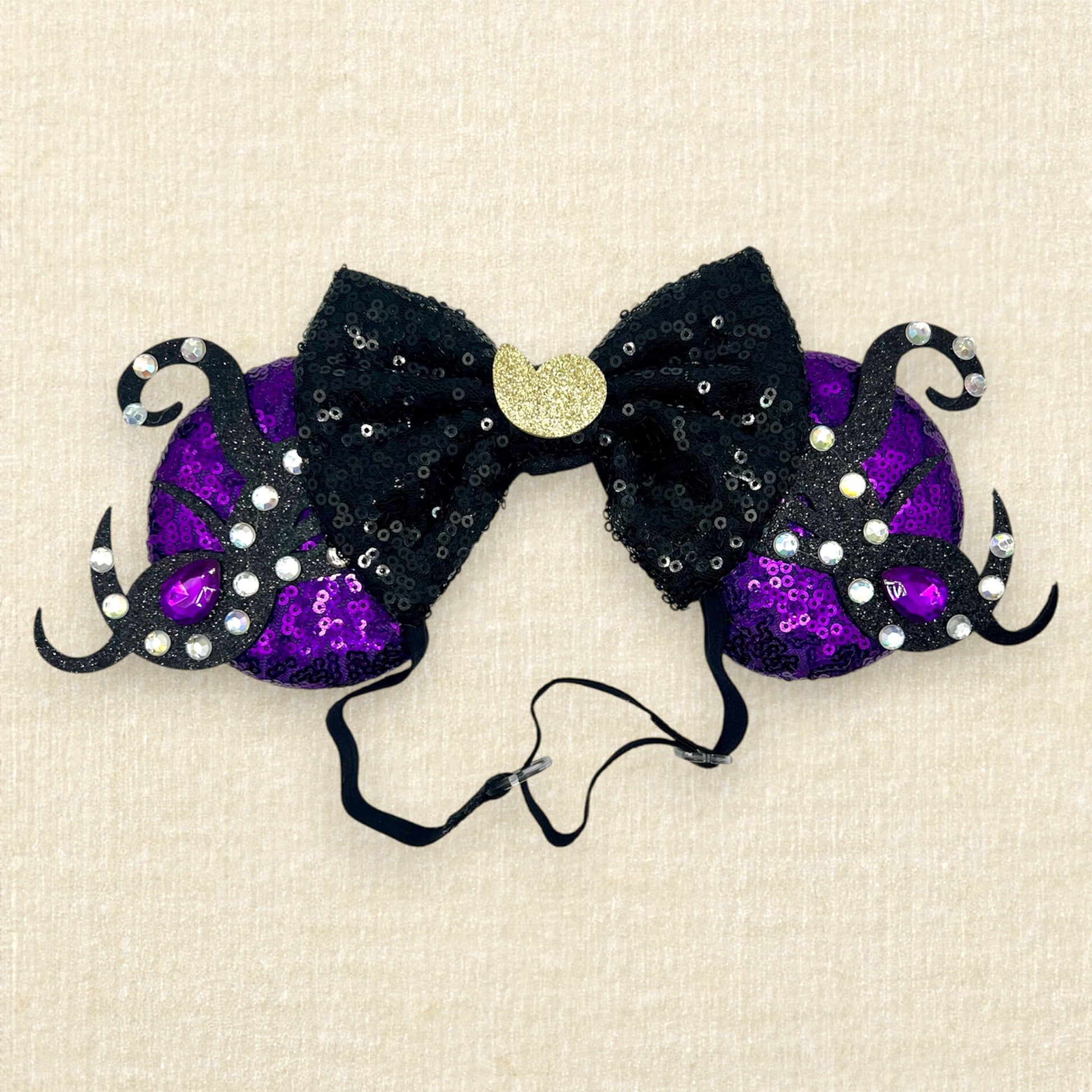 Purple sequin mouse ears with glitter tentacles, rhinestones, and black sequin bow with glitter seashell on an elastic headband
