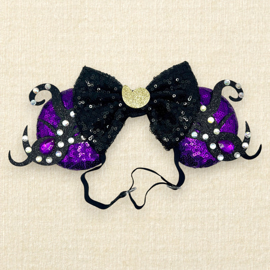 Purple sequin mouse ears with glitter tentacles, rhinestones, and black sequin bow with glitter seashell on an elastic headband
