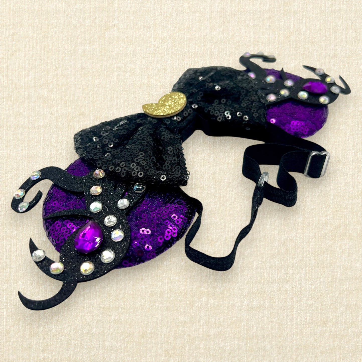 Purple sequin mouse ears with glitter tentacles, rhinestones, and black sequin bow with glitter seashell on an elastic headband