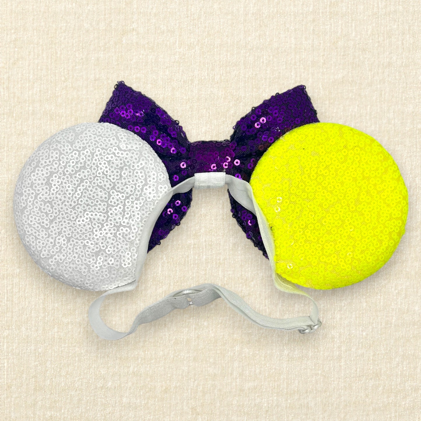 Colorful mouse ears headband with glitter space ranger details and purple sequin bow on an elastic headband (back view)