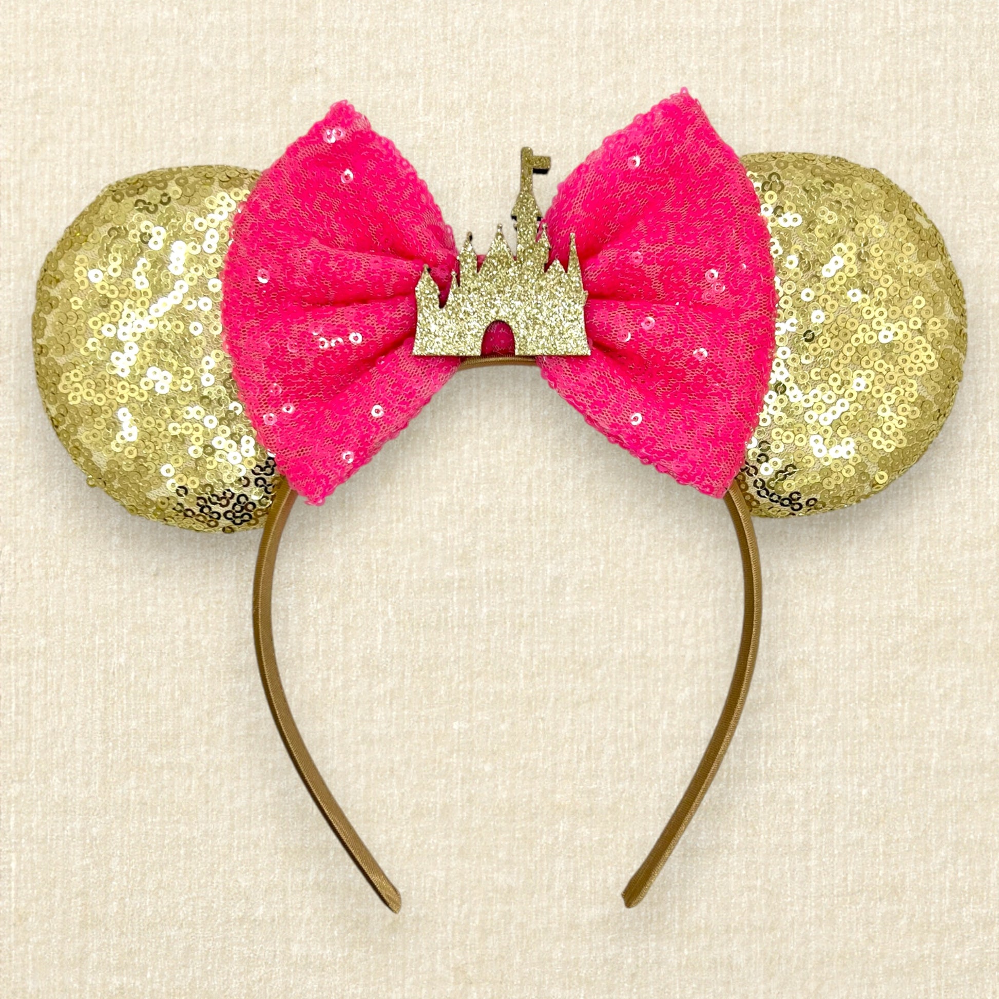 Gold sequin mouse ears with hot pink sequin bow and gold glitter castle