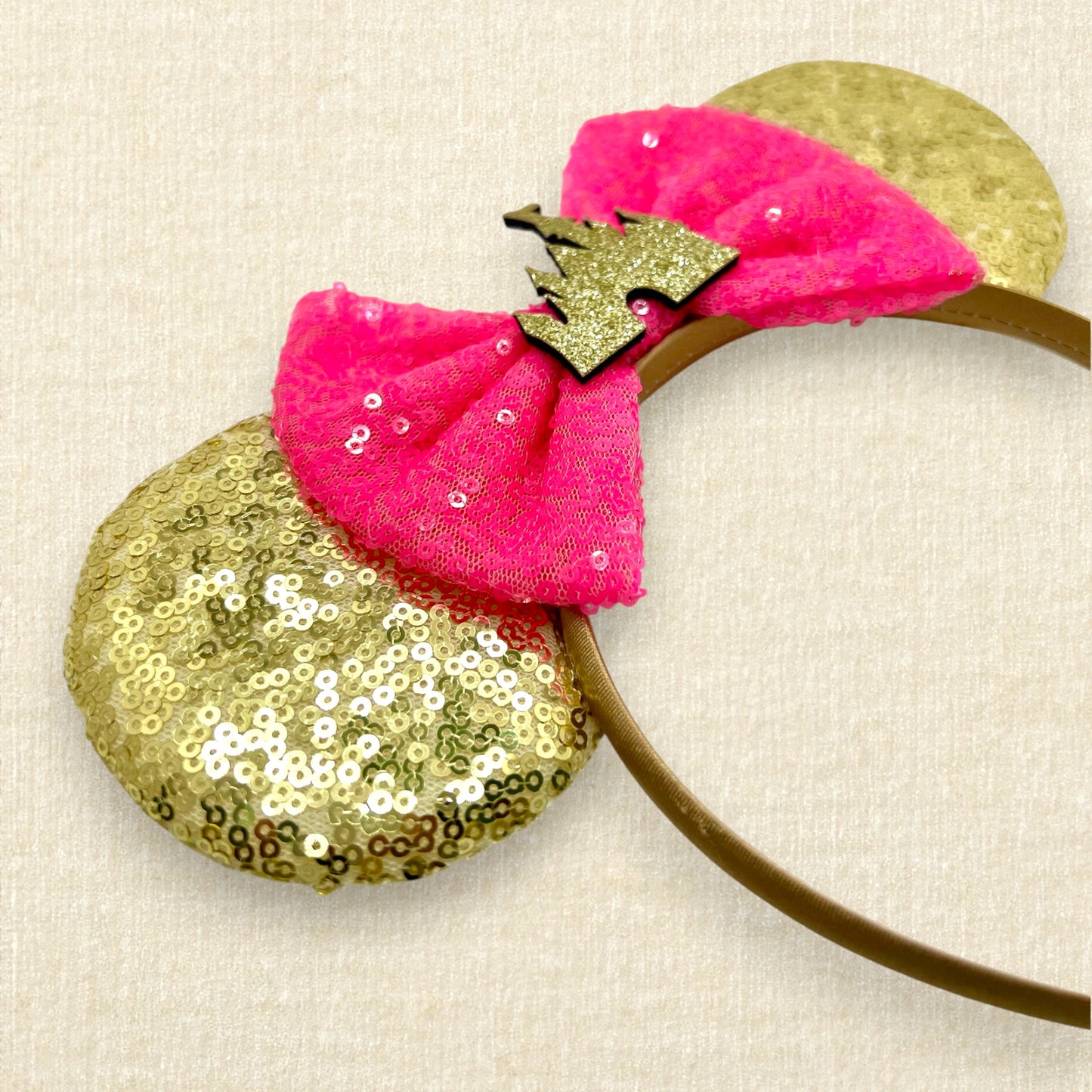 Gold sequin mouse ears with hot pink sequin bow and gold glitter castle
