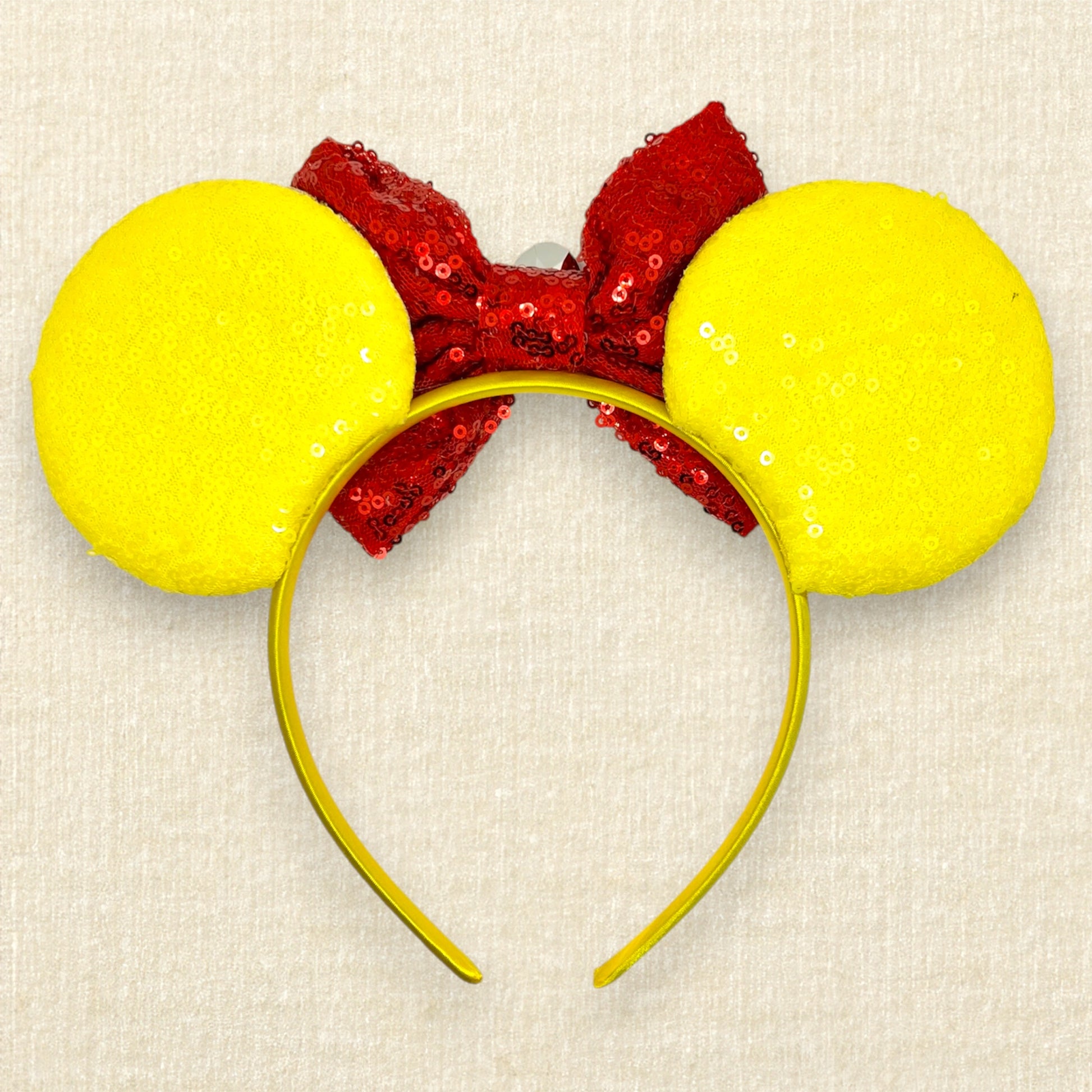 Yellow sequin mouse ears with gold glitter honey and black bumblebee accents, and red sequin bow with wooden honey dipper and gold rhinestone (back view)