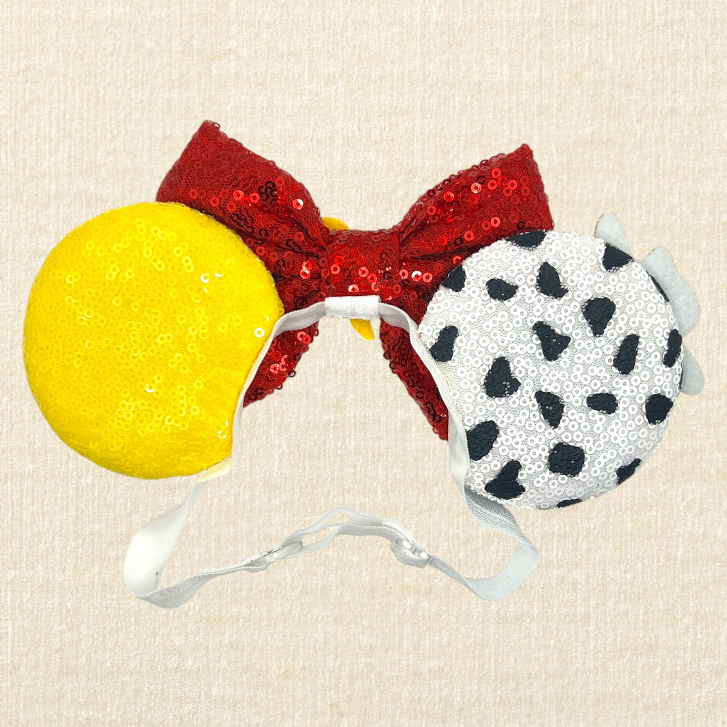 Colorful cowboy-themed mouse ears headband with glitter details, rhinestones, and red sequin bow on an elastic headband (back view)